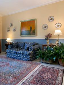 a living room with a blue couch and a rug at Iride Bed and Breakfast in Baronissi