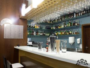 a bar in a restaurant with bottles of alcohol at Hotel Portas De Santa Rita in Ermesinde
