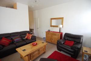 a living room with a couch and a coffee table at Stornoway Apartment in Stornoway