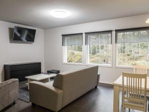a living room with a couch and a tv at Holiday Home Klz krysoliitti by Interhome in Vuokatti
