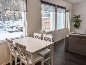 a living room with a table and chairs and a couch at Holiday Home Klz rodoniitti by Interhome in Vuokatti +15 photos