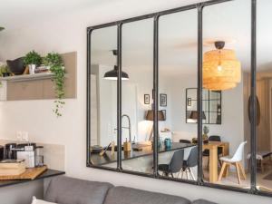 a living room with a large mirror on the wall at Apartment Les Terrasses de la Plage-2 by Interhome in Quiberon