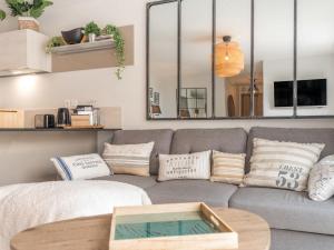 a living room with a couch and a table at Apartment Les Terrasses de la Plage-2 by Interhome in Quiberon
