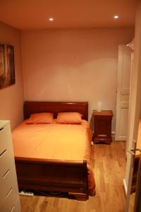 a bedroom with a bed with two orange pillows at SmartRooms, private apart - not shared! Top Quality, 10 in Paris