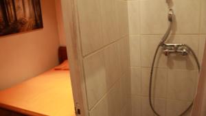 a shower with a hose in a bathroom at SmartRooms, private apart - not shared! Top Quality, 10 in Paris