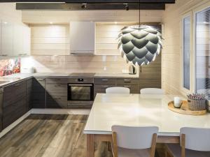 a kitchen with a large white table and chairs at Holiday Home Maaruska a by Interhome in Äkäslompolo