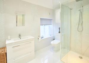 a bathroom with a toilet and a sink and a shower at Host & Stay - Rosella Cottage in Pickering