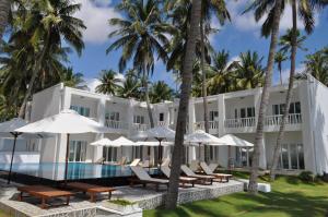 an exterior view of the resort with chairs and umbrellas at Surf4You Residence in Mui Ne