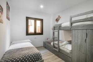 sypialnia z 2 łóżkami piętrowymi i oknem w obiekcie Adriana by Totiaran w mieście Baqueira-Beret