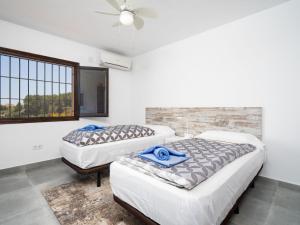 two beds in a room with a window at Apartment Miramar by Interhome in Moraira