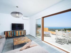 a living room with a couch and a television at Apartment Miramar by Interhome in Moraira