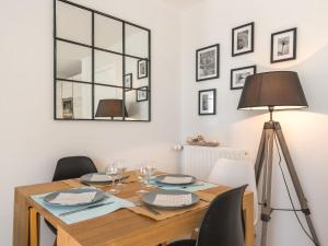 a dining room with a table and a lamp at Apartment Les Terrasses de la Plage-2 by Interhome in Quiberon +16 photos