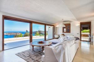 a living room with a couch and a table at Elounda Lavender Villa in Elounda