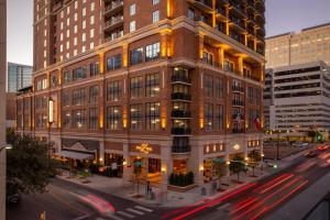 a tall building on a city street with cars at Hotel ZaZa Austin in Austin