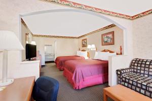 a hotel room with two beds and a tv at Your Place Inn in Millington