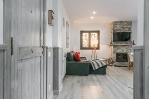 a living room with a green couch and a fireplace at Adriana by Totiaran in Baqueira-Beret