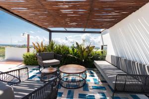 a patio with a table and chairs on a balcony at Riva 202 in Playa del Carmen