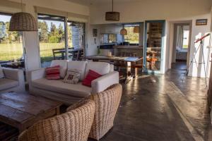 a living room with a couch and a table at Casa en El Quijote Club de Chacras, La Barra, Punta del Este. in Maldonado