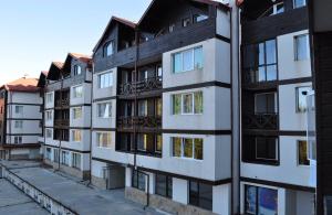 an apartment building with many windows on a street at ComfortApartment IGLIKA 2 in Borovets