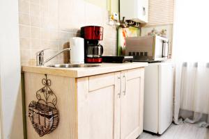 a kitchen with a sink and a microwave at Sunrise Republicii (Old Center) in Braşov +13 photos