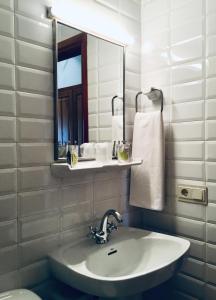 a bathroom with a sink and a mirror at Hostal Can Maret in Fallinas