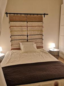 a bedroom with a large bed with two lamps at Capuccino in Sofia
