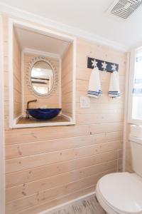 a bathroom with a toilet and a mirror at Tiny House Siesta in Sarasota