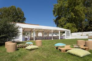 Tienda de campaña con mesas de picnic y sillas en el césped en Quinta do Boição en Lisboa