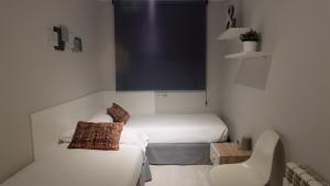 Posteľ alebo postele v izbe v ubytovaní Apartamentos Real Lleida