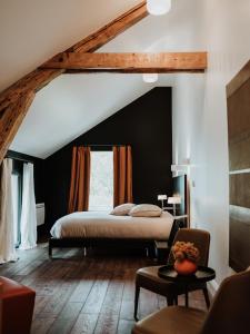 a bedroom with a bed and a large window at Le Clos de la Pomponnette in Pomponne