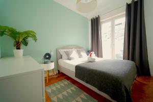 a bedroom with a large bed and a window at Avenidas Cozy Apartment in Lisbon