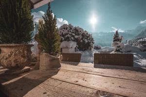 a group of potted trees sitting on a wooden table at Hotel Alpenblick Zillertal in Hippach