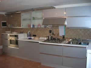 a kitchen with a sink and a stove top oven at La Dimora di Ciccio in Lecce