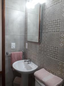 a bathroom with a sink and a mirror and a toilet at Stone Wasi in Montevideo +50 photos