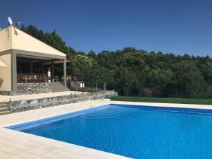 a swimming pool in front of a house at Micro Cabana Rotativa in Bragança