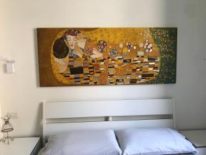 a painting hanging above a bed in a bedroom at Domus Orvieto in Orvieto