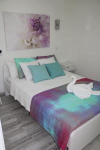 a bedroom with a bed with a swan on it at Solymar Las Olas in Playa del Ingles