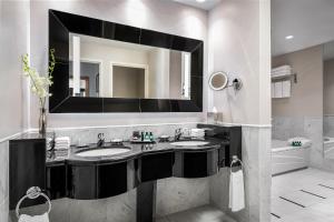
a bathroom with a sink and a mirror at Sofitel Montreal Golden Mile in Montreal
