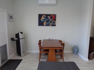 a dining room with a table and a painting on the wall at Erwins Lagoon Retreat in Beachport