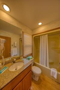 a bathroom with a sink and a toilet and a shower at Sea Spray Motel in Beach Haven