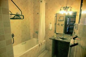 a bathroom with a tub and a sink and a bath tub at Riad Nezha in Merzouga +78 photos
