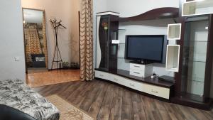 a living room with a flat screen tv on a entertainment center at Podil Apart Kontraktova ploshcha Андріївський узвіз Center in Kyiv
