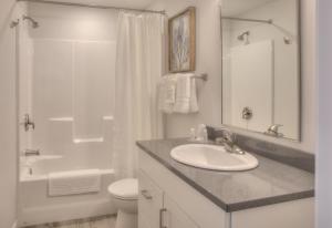 a bathroom with a sink, toilet and bathtub at OCEAN SHORES RESORT - Brand New Rooms in Ocean Shores