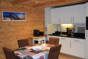 a kitchen and dining room with a table and chairs at Home sweet home in Chamonix