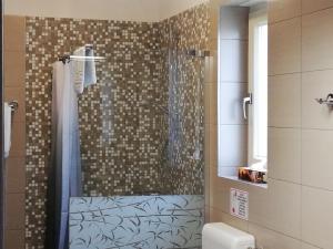 a bathroom with a shower with a glass door at Rooms and Apartments IstraSoley in Bale