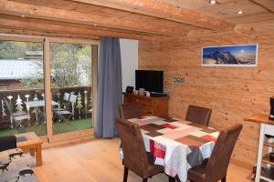 a dining room with a table and a balcony at Home sweet home in Chamonix