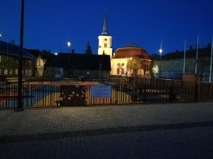 a building with a church with a clock tower at night at Old Town Apartment nr 9 in Valga
