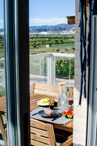 a table with food on a balcony with a view at Chill'n Holidays in Moncófar