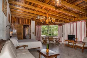 a bedroom with a bed and a living room at Costa Verde Inn in San José