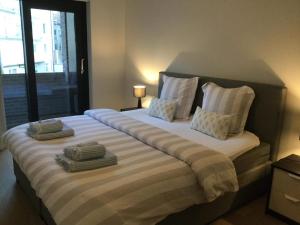 a bedroom with a large bed with two pillows at Ocean Breeze in Ostend